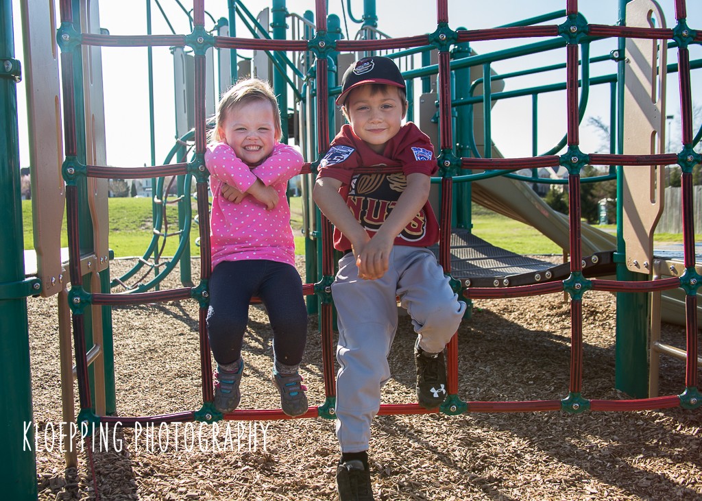 siblings on the play gym